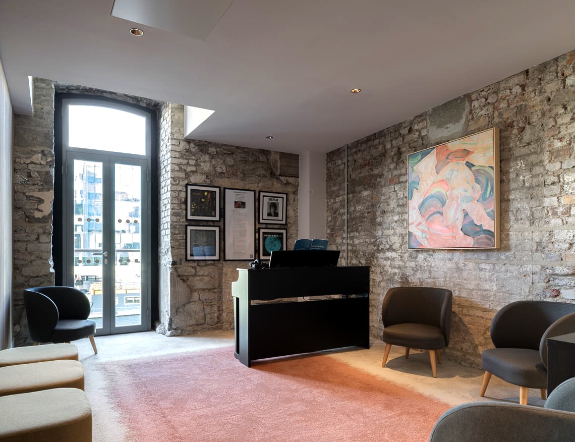 Compact music practice room with a piano, and seating for an additional 7 people